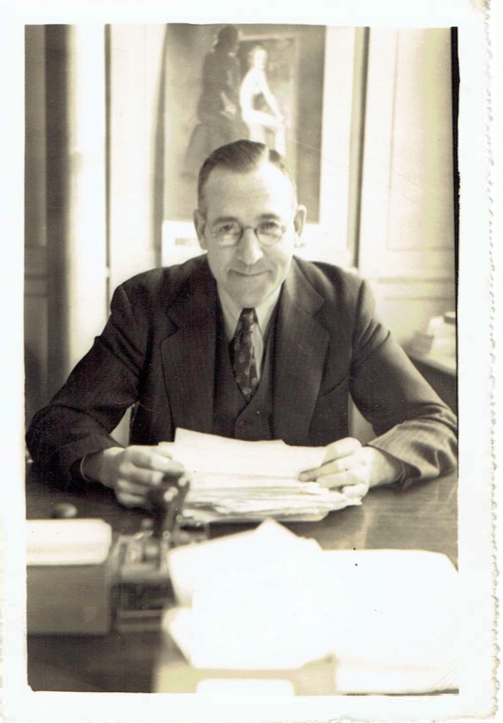 Donald L. Macdonald sitting in his office.